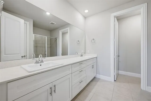 a bathroom with double sink and a mirror