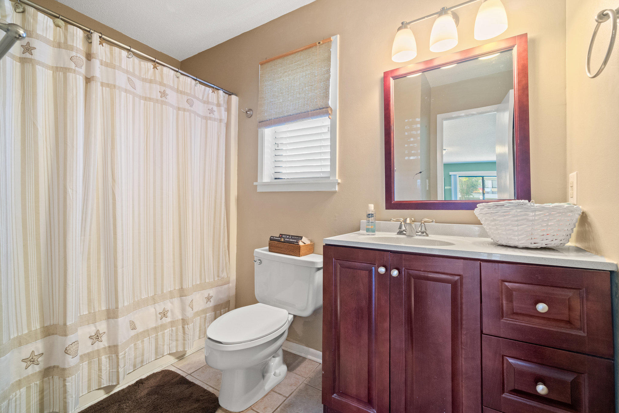 3799 East County Highway 30A, Unit E6 Santa Rosa Beach, FL 32459 - Photo 16 of 23 a bathroom with a granite countertop toilet sink and mirror
