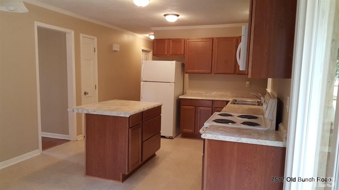 7517 Old Bunch Road Zebulon, NC 27597 - Photo 11 of 25 a kitchen with a stove and a refrigerator
