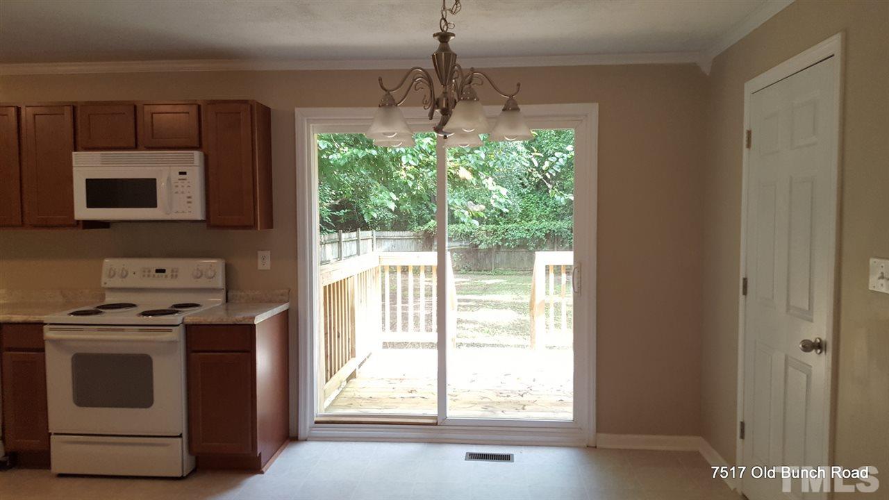7517 Old Bunch Road Zebulon, NC 27597 - Photo 13 of 25 a kitchen with a stove and a microwave