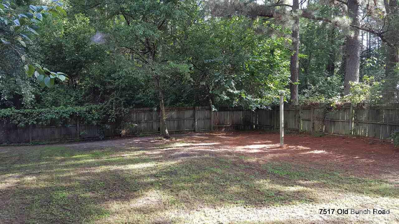 7517 Old Bunch Road Zebulon, NC 27597 - Photo 19 of 25 a backyard of a house with lots of green space