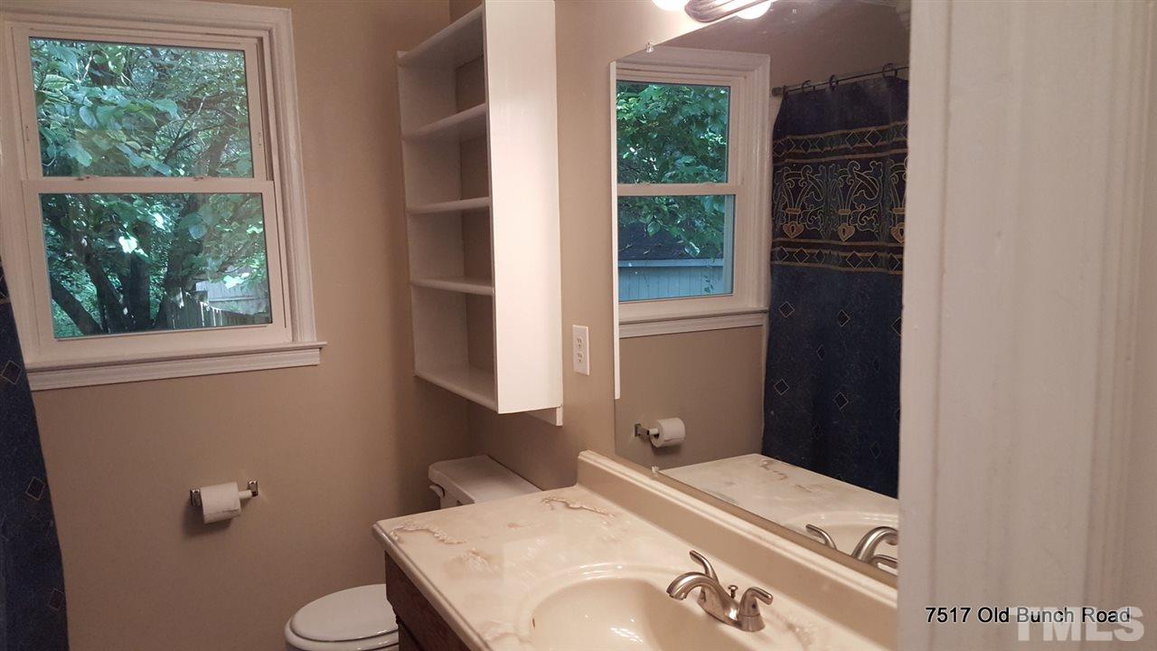 7517 Old Bunch Road Zebulon, NC 27597 - Photo 20 of 25 a bathroom with a sink toilet and window