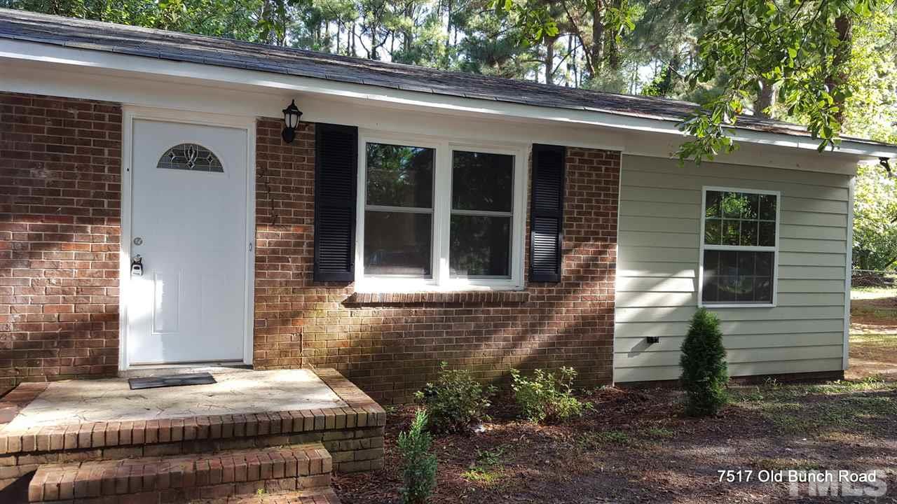 7517 Old Bunch Road Zebulon, NC 27597 - Photo 3 of 25 a front view of a house with garden