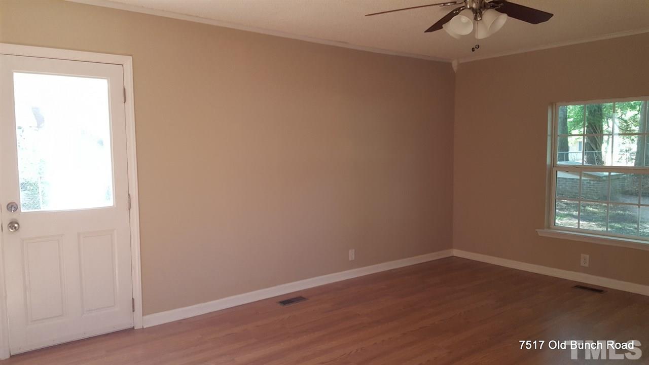 7517 Old Bunch Road Zebulon, NC 27597 - Photo 6 of 25 an empty room with a window and a ceiling fan