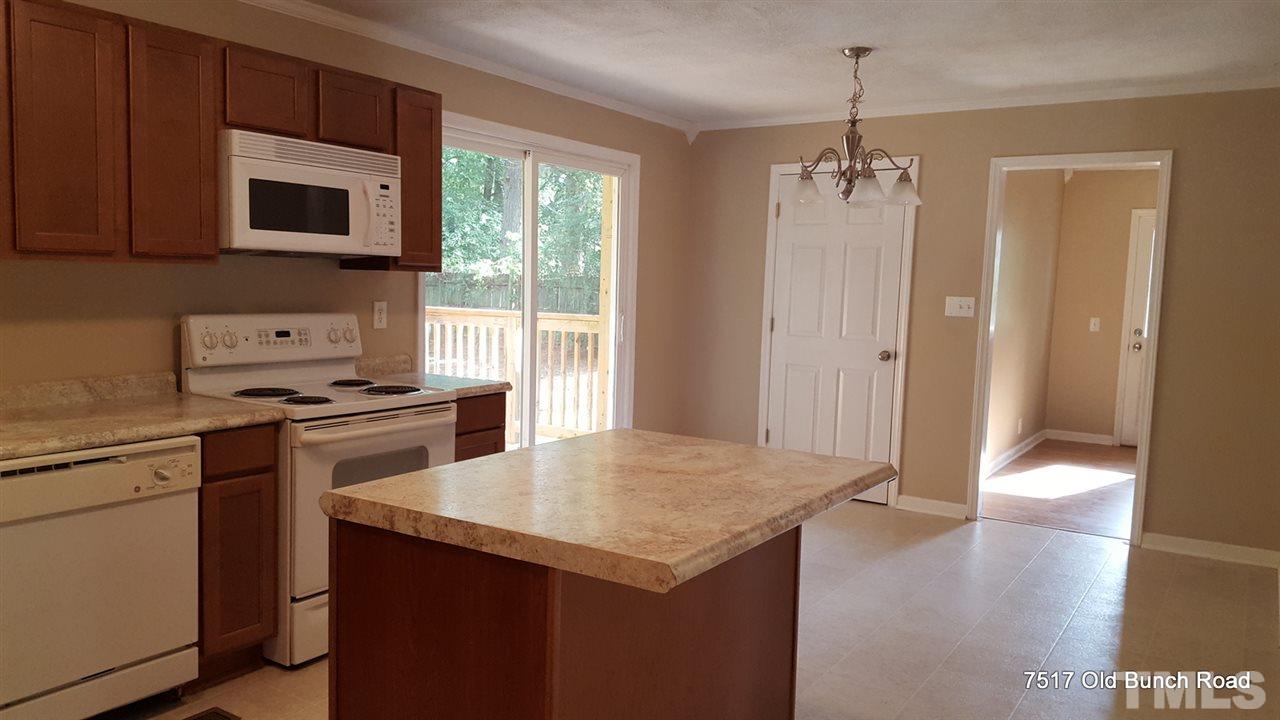 7517 Old Bunch Road Zebulon, NC 27597 - Photo 9 of 25 a kitchen with a stove a sink and a refrigerator