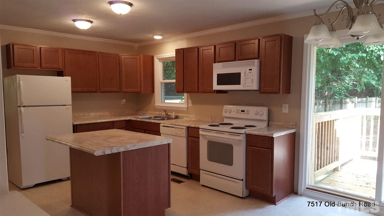 7517 Old Bunch Road Zebulon, NC 27597 - Photo 10 of 25 a kitchen with a stove sink and refrigerator