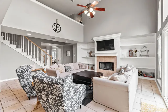 a living room with furniture a fireplace and a flat screen tv