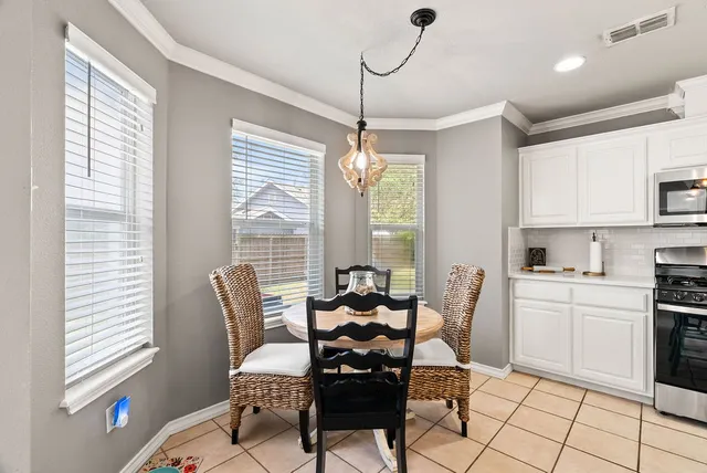 a dining room with furniture and window