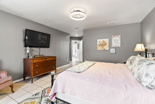 a bedroom with a bed and a flat screen tv