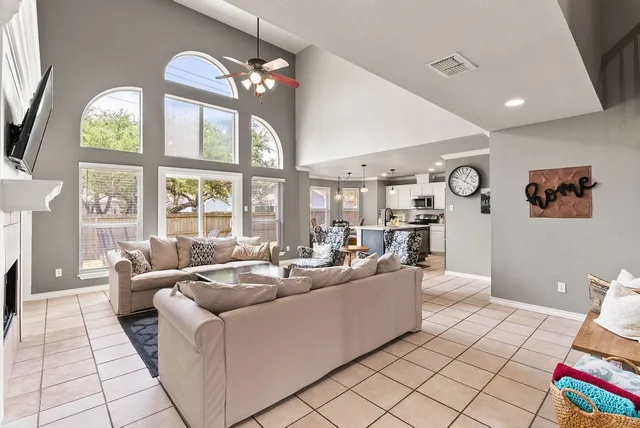 a living room with furniture and a fireplace