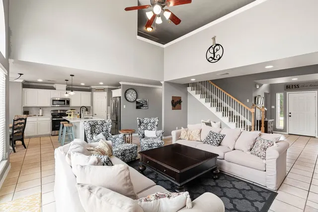 a living room with furniture and a chandelier