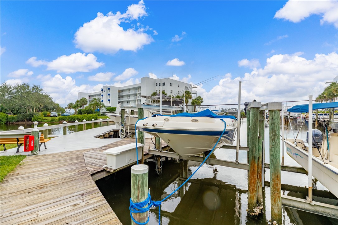 0 River Run Sebastian, FL 32958 - Photo 2 of 3 a roof deck with table and chairs potted plants with wooden floor
