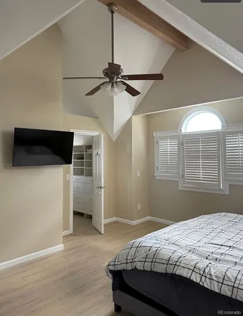 a bedroom with a bed and a ceiling fan