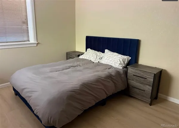 a bed sitting in a bedroom next to a window