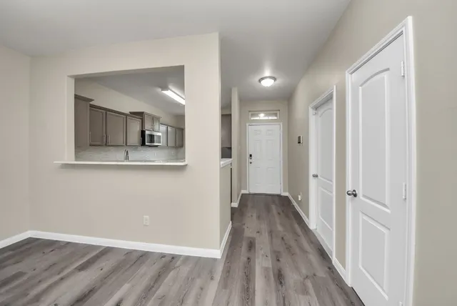 a kitchen with stainless steel appliances granite countertop a sink stove oven and white cabinets