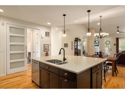 a kitchen with kitchen island a sink table and chairs