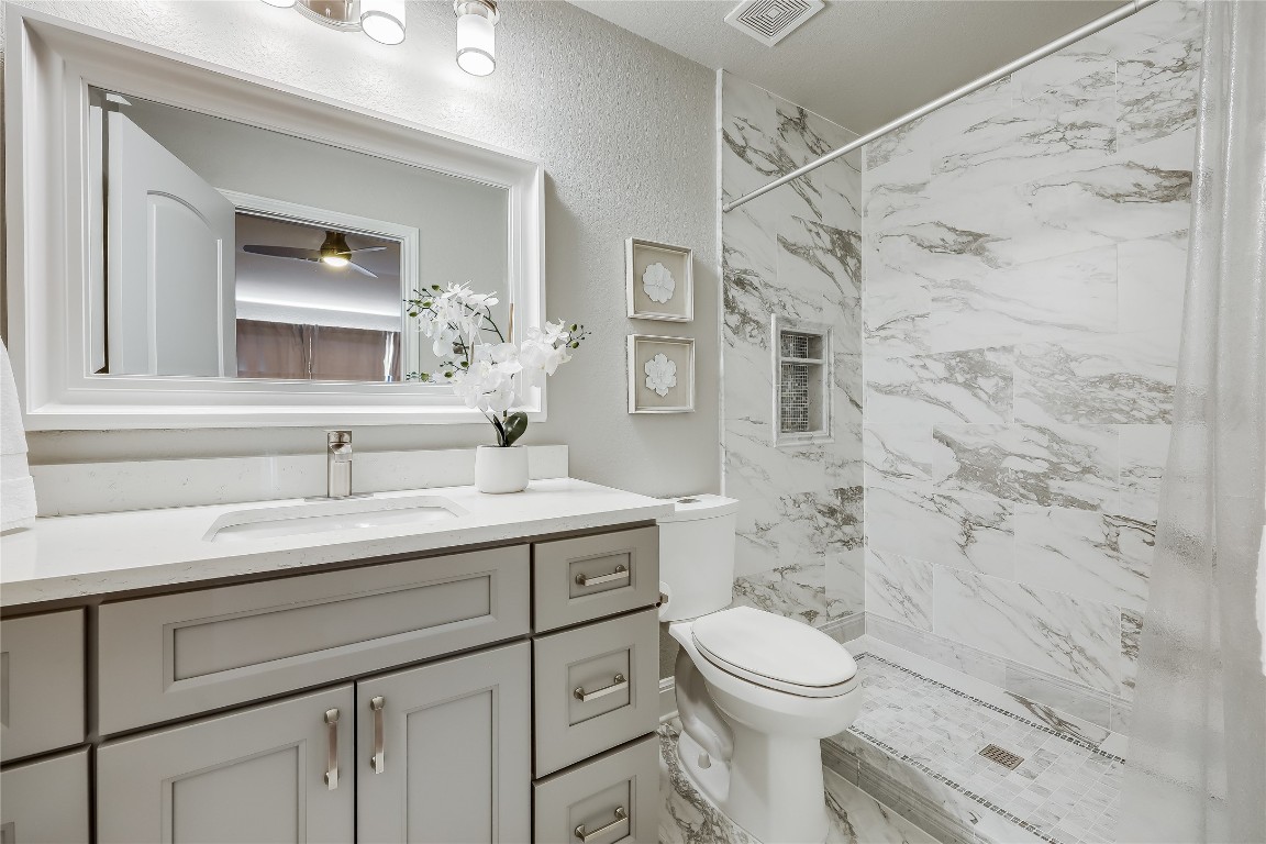 2116 Demona Drive Austin, TX 78733 - Photo 23 of 40 a bathroom with a sink a toilet and shower