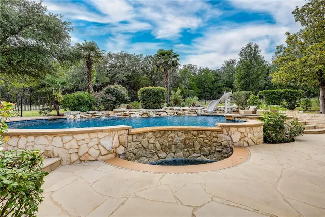 a view of a swimming pool with a yard
