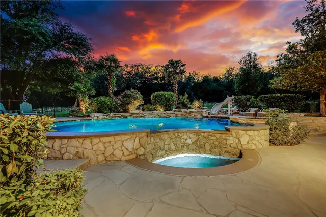 a view of a swimming pool with a yard