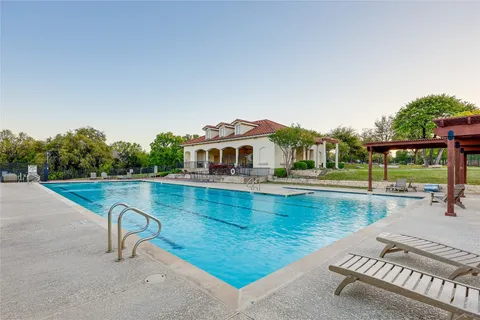 a view of a swimming pool with a lounge chair