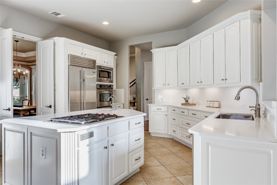 2116 Demona Drive Austin, TX 78733 - Photo 10 of 40 a kitchen with granite countertop a sink stove and cabinets