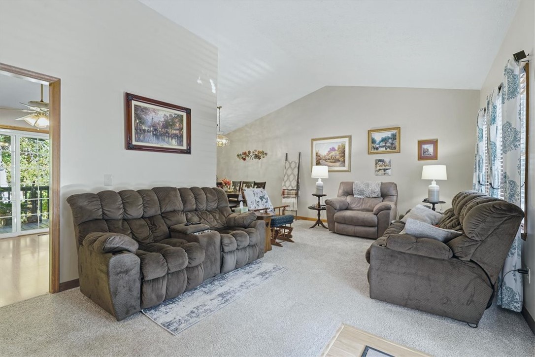 211 Cedar Ridge Drive Westminster, SC 29693 - Photo 5 of 34 An open living room features vaulted ceilings, plush carpeting, and abundant natural light.