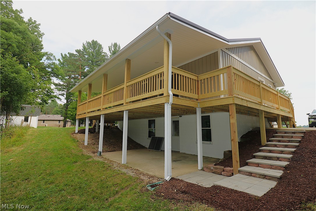 5236 Zenobia Road Wakeman, OH 44889 - Photo 21 of 31 Elevated property featuring a full-length covered deck with wood railing, supported by white columns