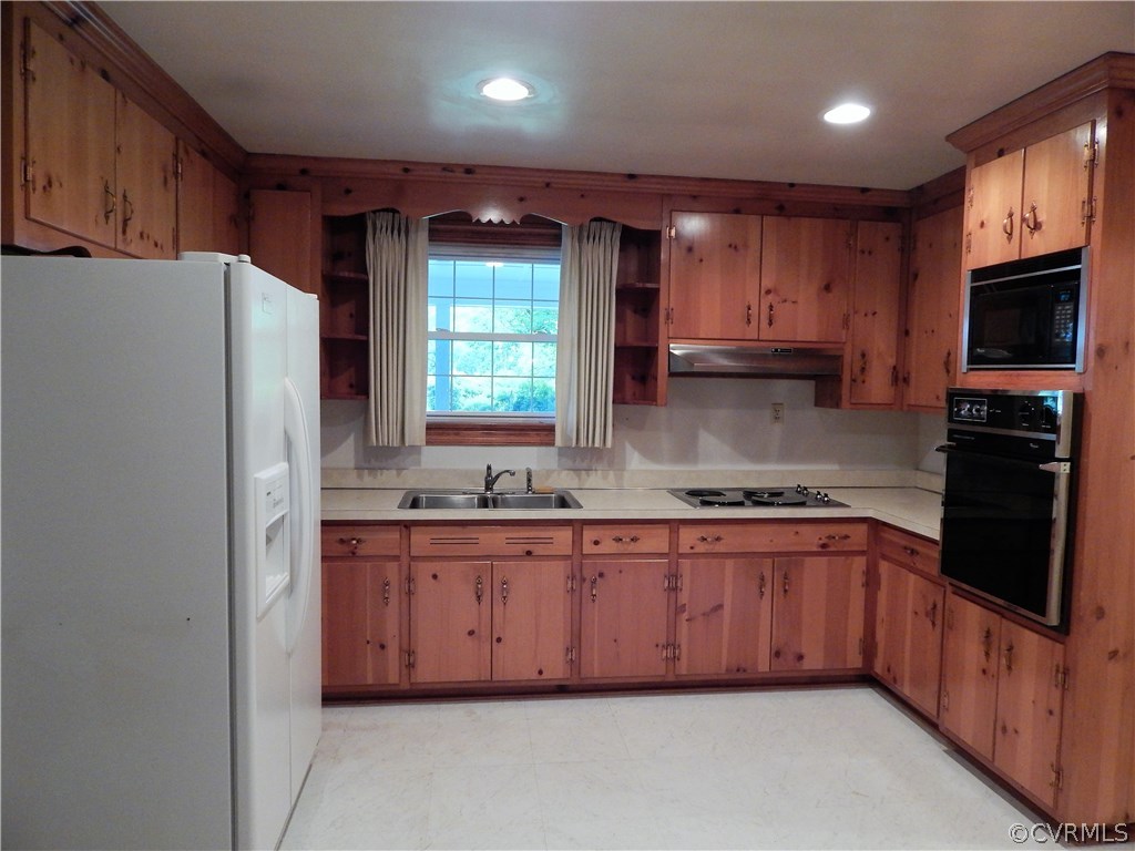 17023 Old Ridge Road Montpelier, VA 23192 - Photo 10 of 19 a kitchen with stainless steel appliances granite countertop a refrigerator a sink a stove a microwave and wooden cabinets