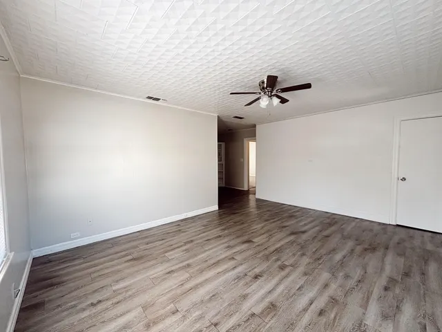 a view of a livingroom with a ceiling fan and window