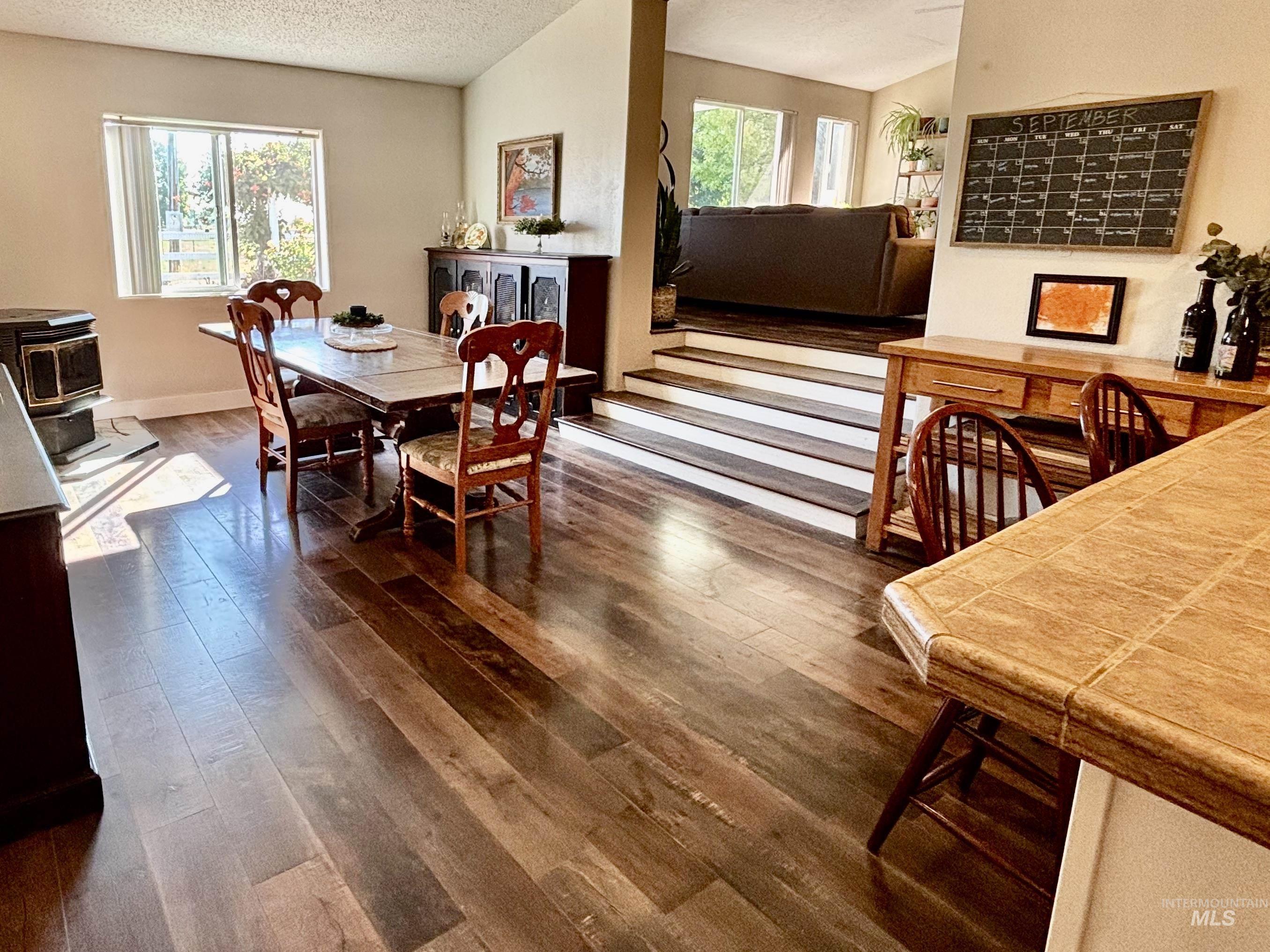 23626 Boise River Road Caldwell, ID 83607 - Photo 14 of 49 Wood-finish flooring, vaulted ceilings, and a built-in wood-burning stove