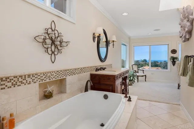 a bedroom with a bed and large windows