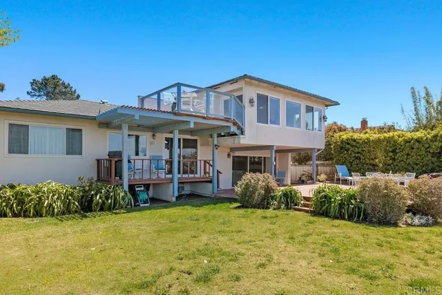 a view of a balcony with two chairs and a table