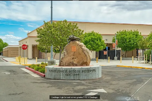 a view of street along with house and trees