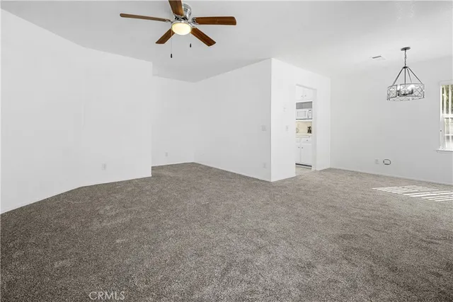 a view of a room with a ceiling fan
