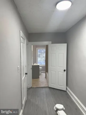 a view of a room with wooden floor and cabinet