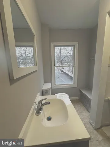 a bathroom with a sink and a window