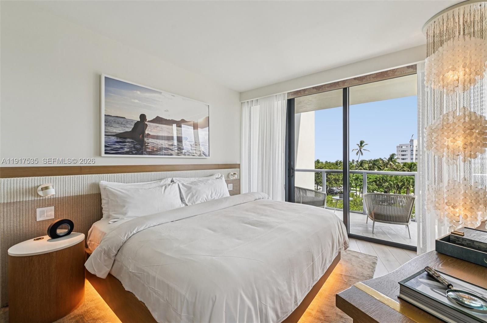 2201 Collins Avenue, Unit 401 Miami Beach, FL 33139 - Photo 2 of 20 a bedroom with a bed and a large window