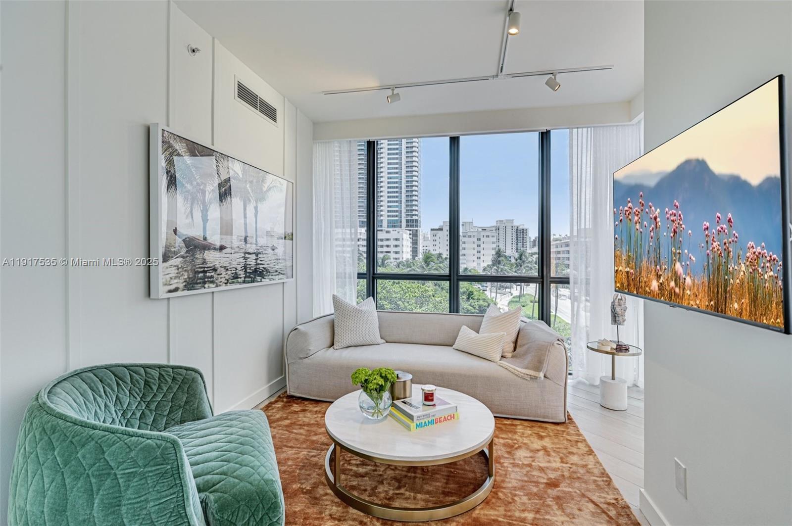 2201 Collins Avenue, Unit 401 Miami Beach, FL 33139 - Photo 3 of 22 a living room with furniture and a large window