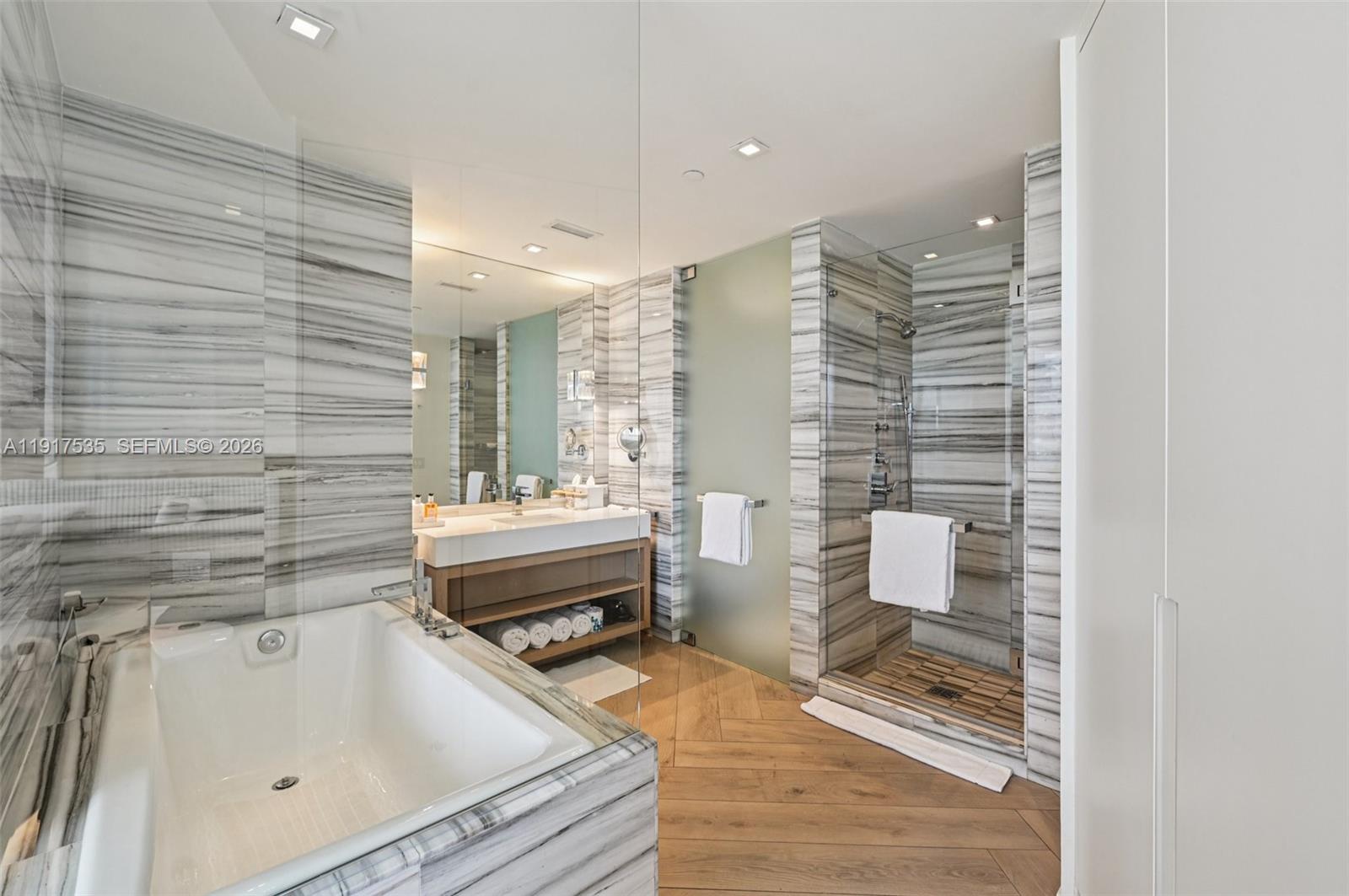 2201 Collins Avenue, Unit 401 Miami Beach, FL 33139 - Photo 5 of 20 a bathroom with a sink and a mirror