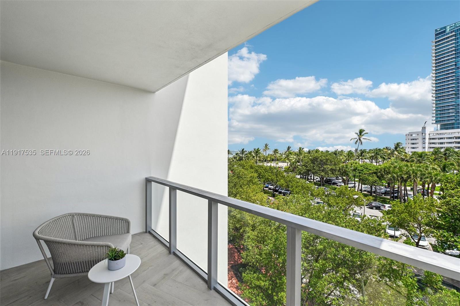 2201 Collins Avenue, Unit 401 Miami Beach, FL 33139 - Photo 8 of 20 a view of a chair and table in the balcony