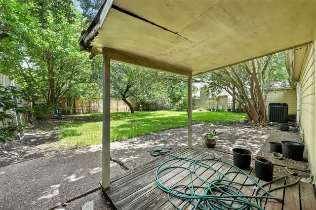 a view of a porch with furniture and garden