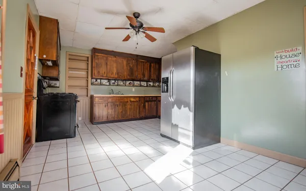 a kitchen with stainless steel appliances granite countertop a refrigerator and a stove