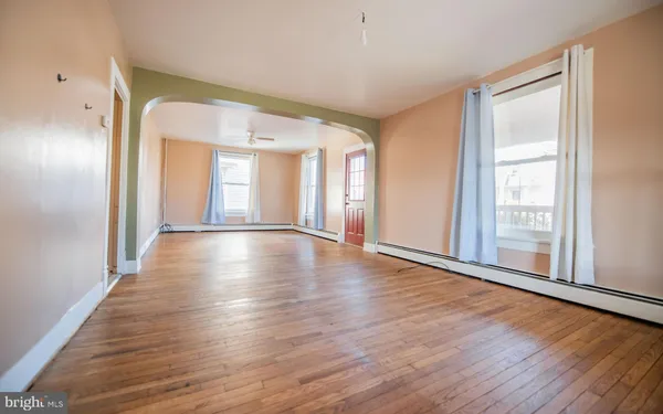 wooden floor in an empty room with a window