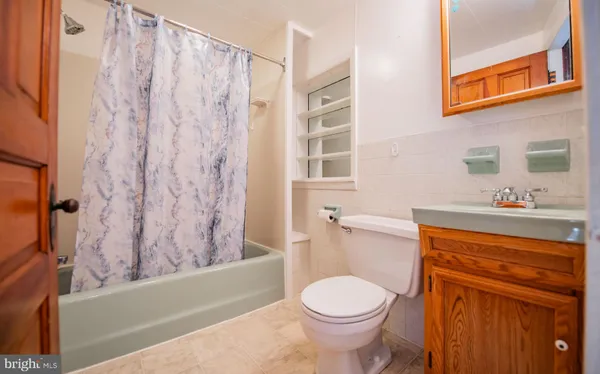 a bathroom with a sink a toilet and a bathtub