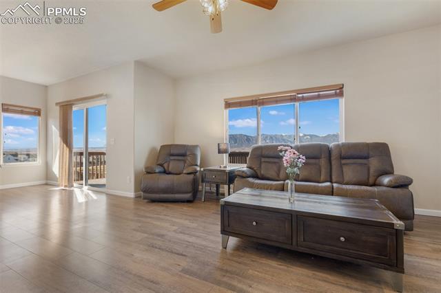 4540 Sierra Rica Road Colorado Springs, CO 80911 - Photo 12 of 42 Living area featuring wood finished floors and ceiling fan