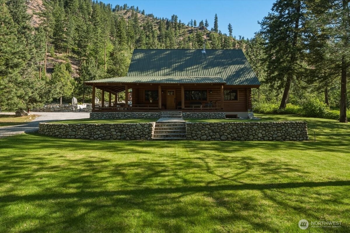 2250 First Crk Road Chelan, WA 98816 - Photo 4 of 39 a front view of a house with a yard table and chairs