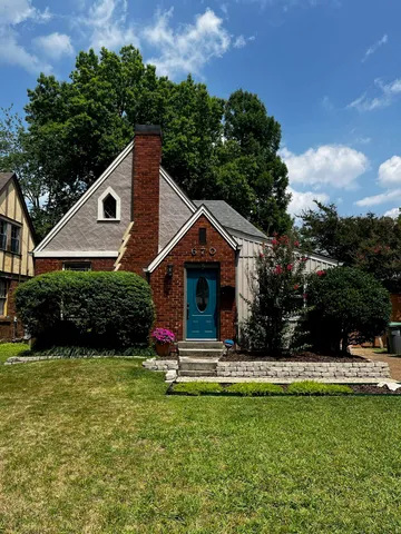 a front view of house with yard and green space