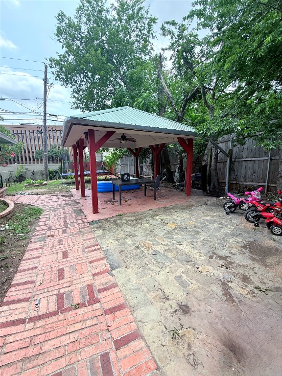 7707 Eastcrest Drive, Unit B Austin, TX 78752 - Photo 4 of 11 a view of a patio with a table and chairs under an umbrella