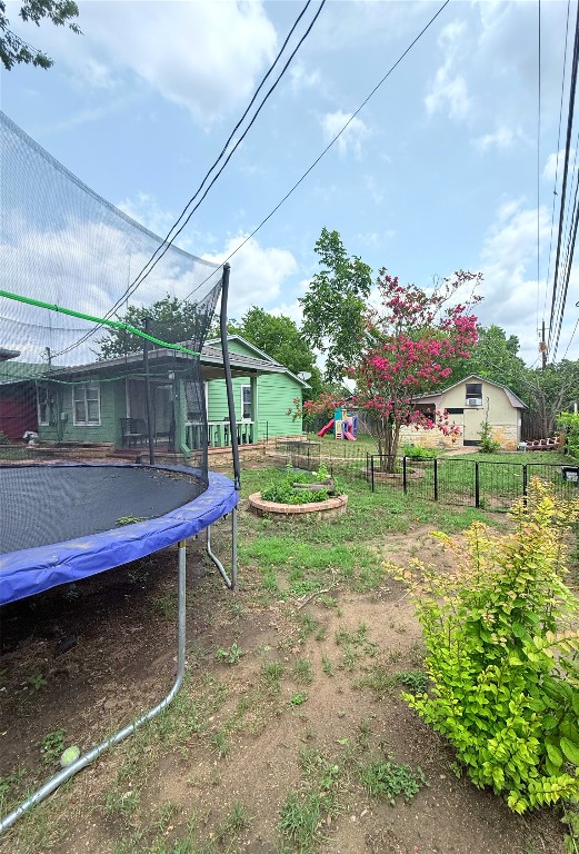 7707 Eastcrest Drive, Unit B Austin, TX 78752 - Photo 10 of 11 a backyard of a house with table and chairs