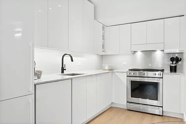 a kitchen with a sink stove and cabinets